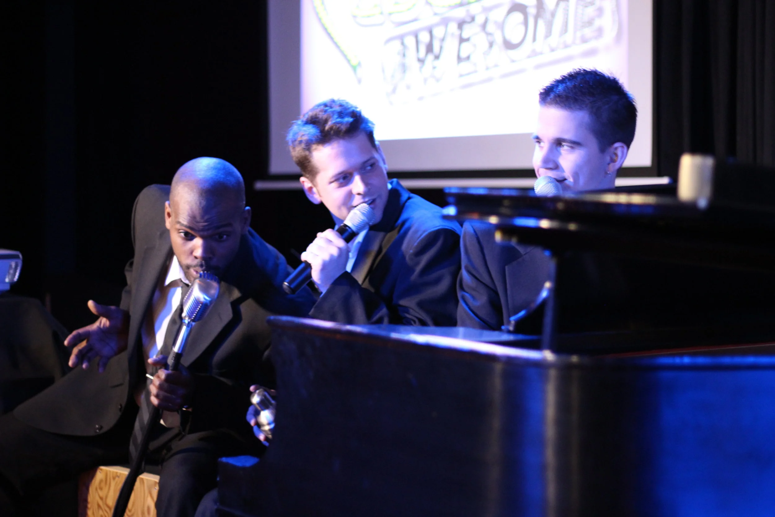Awesome Gentlemen’s Society performing around a piano